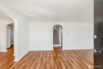 Home enters into the living room with tons of natural light and charming archways.
