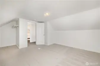 Alternate view of the upstairs bedroom showcasing charming architectural details.