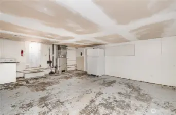 Converted garage space offers abundant overhead storage, while providing excellent workshop or hobby space.