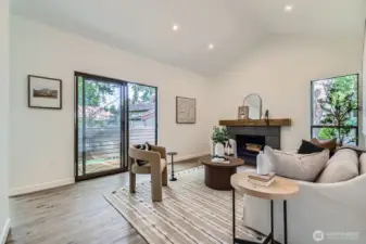 Bright & Spacious Living Looks Out onto Park-Like Courtyard & Cozy Fireplace