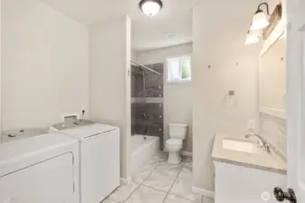 Full bathroom with laundry area