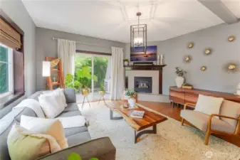 Stylish living room with warm natural textures, abundant light, and seamless flow to a side porch and cozy patio