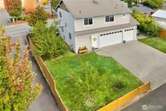 Elevated view of the back of the home showcases its generous lot, private alley access and lush landscaping