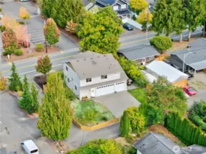 Another drone perspective of the back of the home, highlighting its corner lot placement