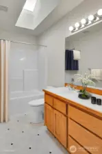 Virtually staged upper level bath.