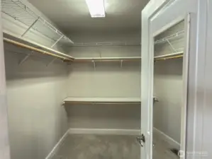 Primary walk-in closet, with lots of storage space.