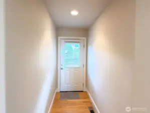 Back door accessible at the end of the hallway, leading to the backyard patio via a ramp.