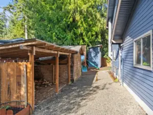 Wood storage shed. Seller grows roses, tomatoes and more on the side.