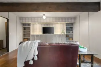 Family/rec room has new custom shelving and storage. Perfect space for your big screen!