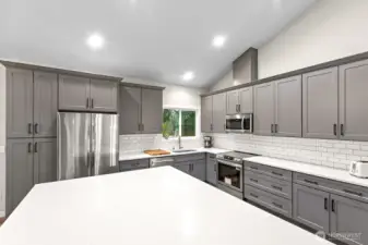 The oversized island takes center stage, providing the perfect gathering spot for entertaining family and friends.