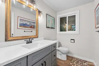 A stylishly updated half bath is conveniently located on the lower level.