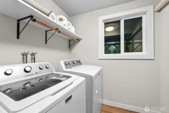 The lower level offers a roomy walk-in laundry with full-sized washer and dryer, plus a window for added light.