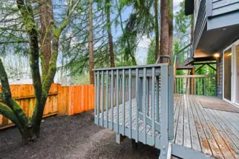 Step out from the family room to the lower deck, complete with a gate and stairs to the upper deck. A small, easy-care side yard sits beside the deck, with a path outside the fence gate leading to the lower yard.  Note-All decks just painted in Feb 2026.