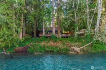 View of backyard from the river -- concrete steps down to the riverfront along the left side of this photo