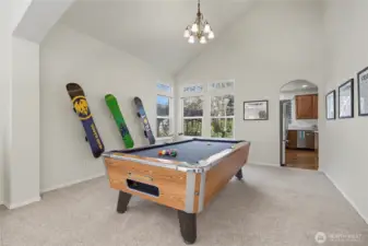 Formal dining room, currently used as a billiards room. Plenty of room, nice fixture and windows. I love the arches in this home as well. Pool table is for sale.