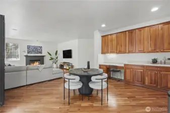 View of your dine-in kitchen area and family room from the kitchen. I love the gas fireplace, one of THREE in this magnificent home. The long buffet area and planning desk is an amazing added benefit.