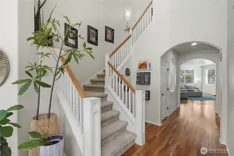 View of your staircase leading up form your entry, hallway to your family room, bath and bedroom/office to your right.