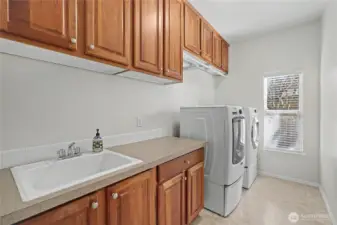 Large utility room with large sink, folding counter and look at all those cabinets!