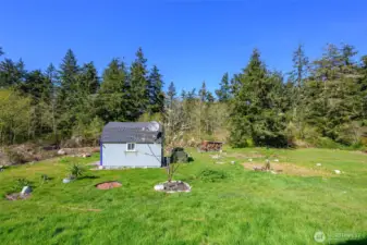 Front yard various shrubs and Cherry Trees visible