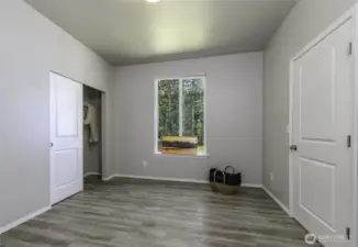 This bedroom has easy to clean floors, no carpet. Could be used for a gym.