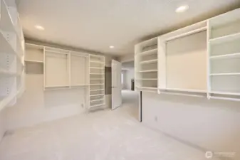You'll be impressed by the dressing room attached to the primary suite. with custom shelving and organizers.  Another view of the immense closet.