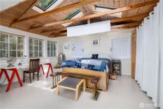 Spacious primary with skylights, originally added on as an artists studio