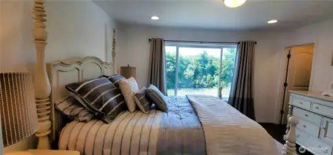 Wake each morning to the peaceful beauty of canal views from this serene primary bedroom. Soft natural light fills the space, highlighting the inviting bed and tranquil decor, while lush greenery just outside the window adds a touch of coastal calm to your daily routine. A true Surfside sanctuary in every sense.