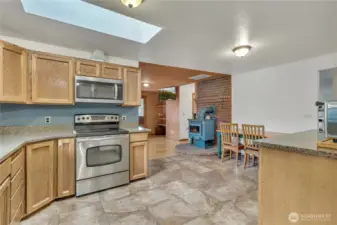 A wood-burning stove warms the kitchen and family room. Room for a casual dining space in the kitchen.