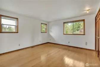 Main level primary bedroom with lots of windows.