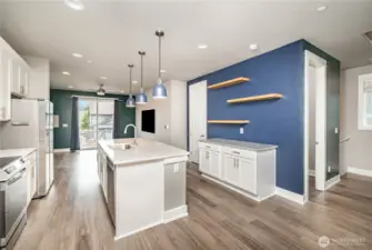 Kitchen also features versatile space with floating shelves—ideal for a coffee bar, stylish display, or home organization hub.