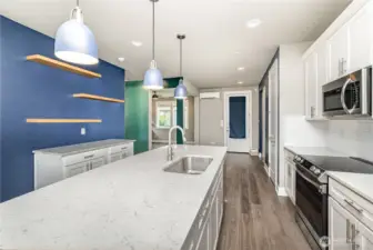 Another view of this open kitchen highlights its spacious layout, modern finishes, and seamless flow into the living areas.