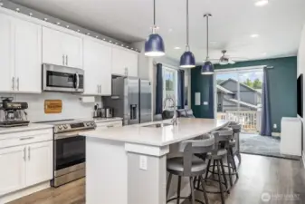 Another view of this open kitchen highlights its spacious layout, modern finishes, and seamless flow into the living areas.