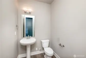 Main floor powder room includes a convenient outlet behind the toilet—perfectly suited for bidets or smart toilet seats.