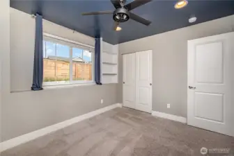 Another view of the guest bedroom highlights the ceiling fan and convenient wall switch—every room is pre-wired and equipped for added comfort.