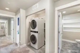 Downstairs hallway offers convenient washer and dryer access near the bedrooms. The home also features Mysa Smart WiFi thermostats controlling each in-wall heater and the AC/mini-split for personalized comfort.