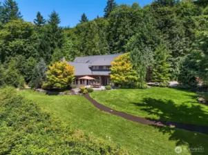 Mature Landscaped grounds and gardens with sprinkler system, paved road complete this one-of-a-kind Estate