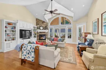 Great room has 12' vaulted ceilings, custom built home entertainment center, and stone fireplace with gas insert.