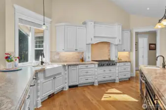 Undermount farm sink with window overlooking the rose garden.  Built-in trash compacter.  Wolf 6-burner gas cook top!