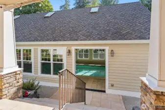 Steps from the patio lead down to the entrance to the pool house!