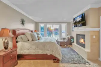 Primary bedroom on the main with private balcony and dual sided fireplace