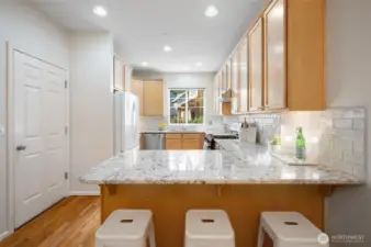 Breakfast bar with seating for casual meals. Walk-in pantry with ample storage space.