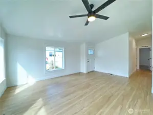Living area connected to back door, which leads to a private patio area.