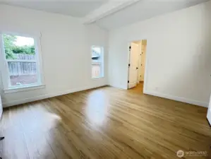 Primary bedroom with north facing windows. Primary bedroom includes a walk in closet, and a private primary bathroom. Door to primary bathroom in picture.
