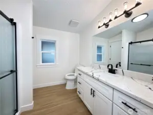 Primary bathroom. Brand new, just installed cabinet, quartz countertop, sink, faucet, toilet, doors, flooring.