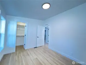 Secondary bedroom. All new floors, new windows, new light fixture, new closet kit, freshly painted.