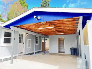 Large carport with two attached sheds.