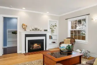 Formal living with gas fireplace and access to private studio space & 1/2 bath