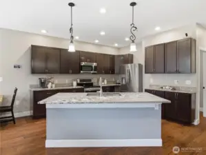 Corner style kitchen with oversized island- room for barstools to add extra convenient seating