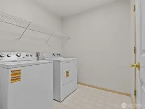 Just inside the garage is the laundry/mud room with brand new washer and dryer that have never been used.