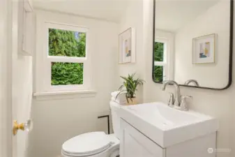 The upstairs has this convenient half bath with new flooring, window, vanity and fixtures.